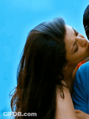 Woman Kissing Man On Cheek Blue Sky GIF