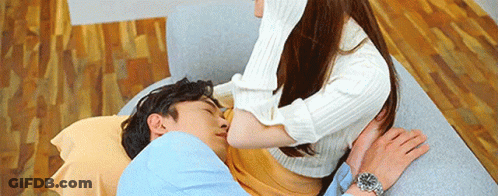 Woman Kissing Man On Couch GIF
