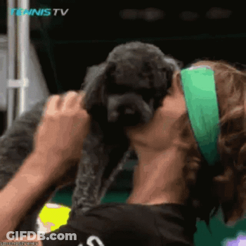 Woman Kissing Small Dog's Cheek At Tennis TV Logo GIF