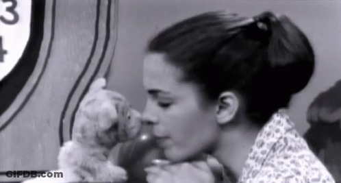 Woman Kissing Stuffed Animal In Black And White Photo GIF