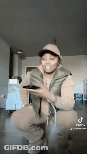 Woman Kneeling Holding Cell Phone GIF