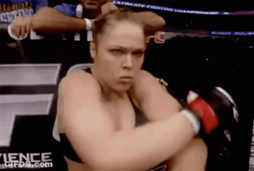 Woman Kneeling In Boxing Ring With Gloves GIF