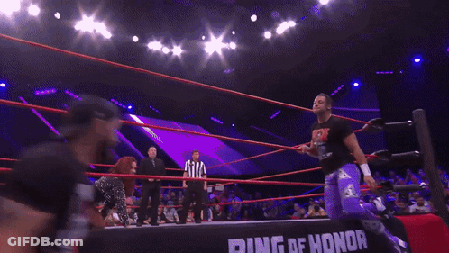 Woman Kneeling In Wrestling Ring In Front Of Honor Banner GIF