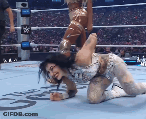 Woman Kneeling In Wrestling Ring With Letter W GIF