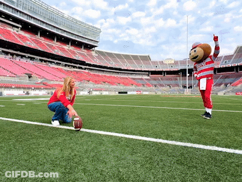 Woman Kneeling Next To Ohio State Football Mascot GIF