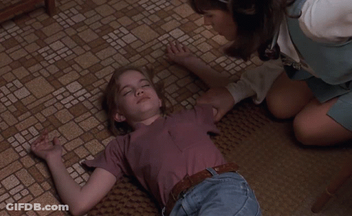 Woman Kneeling Over Girl On Floor GIF