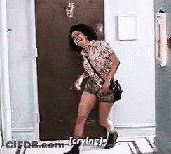 Woman Laughing And Crying In Front Of Door GIF