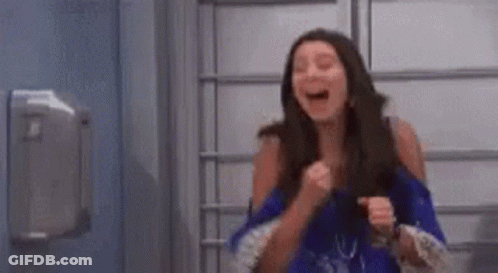 Woman Laughing And Holding Fist In Air GIF