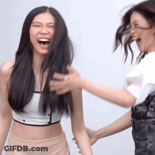 Woman Laughing As Another Holds Arm GIF