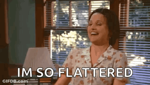 Woman Laughing By Window Saying I'm So Flattered GIF