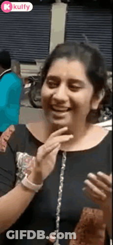 Woman Laughing Covering Mouth On Cell Phone GIF
