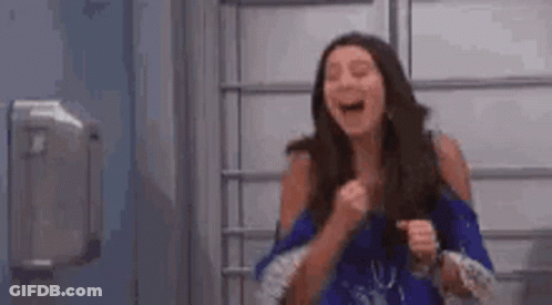 Woman Laughing Holding Fist In Air GIF