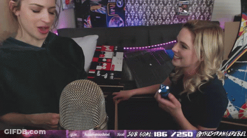 Woman Laughing In Front Of Microphone GIF