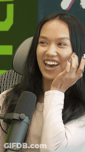 Woman Laughing Into Microphone Green Background GIF