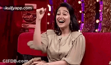 Woman Laughing On Red Couch GIF