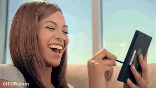 Woman Laughing While Applying Makeup GIF