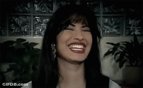 Woman Laughing With Eyes Closed Near Plant GIF