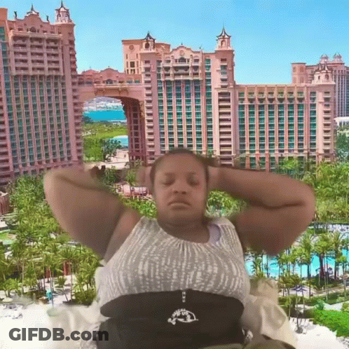 Woman Laying Down In Front Of Building With Palm Trees GIF