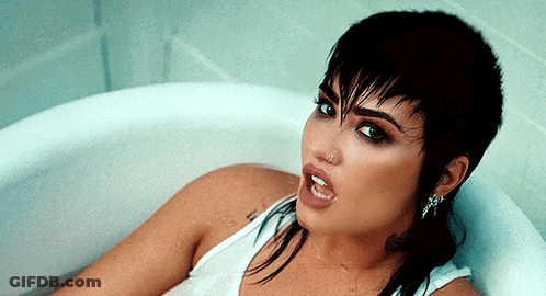 Woman Laying In Bathtub With Nose Ring GIF