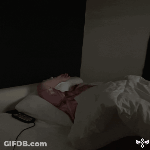 Woman Laying In Bed Saying Goodnight GIF