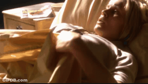 Woman Laying In Bed With Magazine On Nightstand GIF