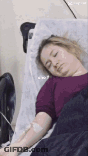 Woman Laying In Hospital Bed With IV And Question Mark GIF