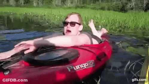 Woman Laying In Red Plunger Kayak In Lake GIF