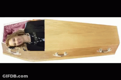Woman Laying In Wooden Coffin Head Out GIF