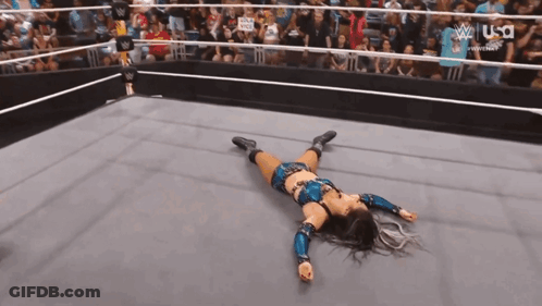 Woman Laying In Wrestling Ring Crowd Watching GIF