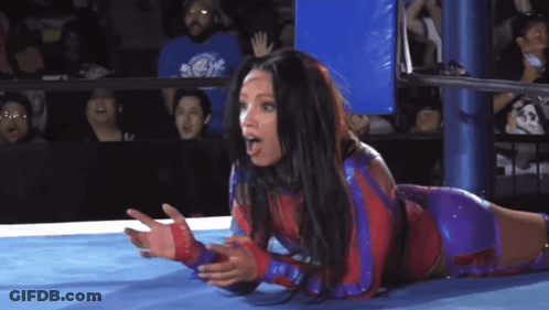 Woman Laying In Wrestling Ring With Hands Outstretched GIF