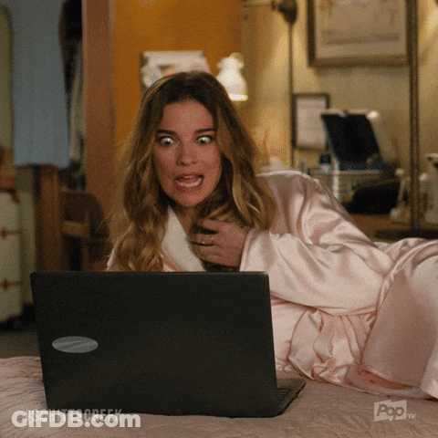 Woman Laying On Bed Looking At Laptop With Schittscreek GIF
