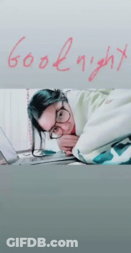 Woman Laying On Bed Saying Goodnight GIF