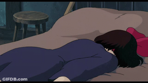 Woman Laying On Bed With Black Cat Walking Over Her GIF