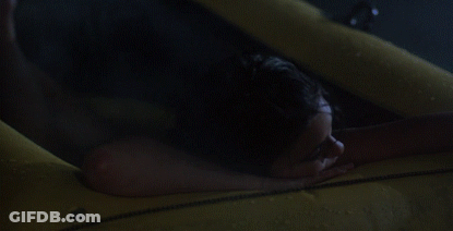 Woman Laying On Bed With Man Holding Her Breasts GIF