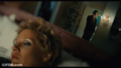 Woman Laying On Bed With Man Standing In Background GIF