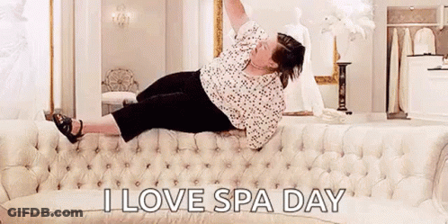Woman Laying On Couch Arms Up Saying I Love Spa Day GIF