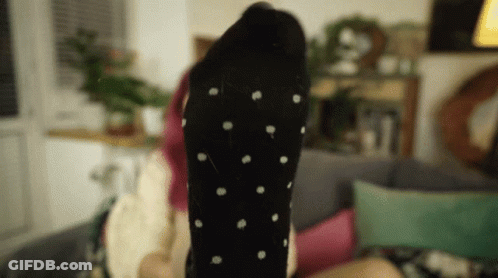 Woman Laying On Couch Feet Up Black Polka Dot Socks GIF