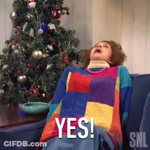 Woman Laying On Couch In Front Of Christmas Tree Saying Yes GIF
