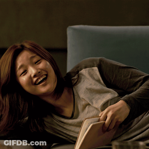 Woman Laying On Couch Reading Book GIF