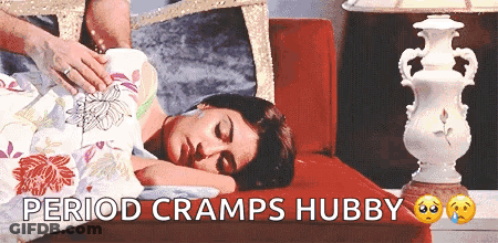 Woman Laying On Couch Saying Period Cramps Hubby GIF