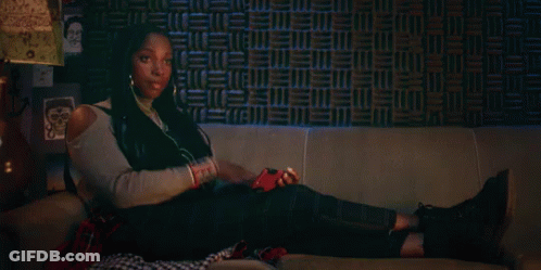 Woman Laying On Couch With Headphones And Phone GIF