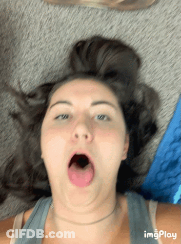 Woman Laying On Floor With Mouth Open GIF