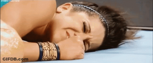 Woman Laying On Ground With Eyes Closed And Hand On Face GIF