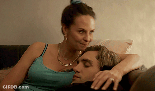 Woman Laying On Man's Lap On Couch GIF