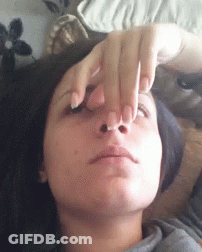 Woman Laying On Stomach Holding Nose GIF