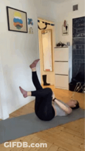 Woman Laying On Yoga Mat Legs Up GIF