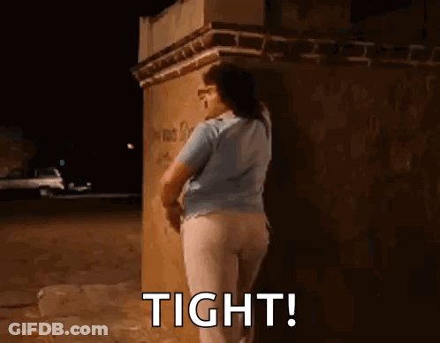 Woman Leaning Against Brick Wall At Night GIF