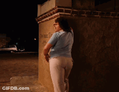 Woman Leaning Against Brick Wall With Graffiti I'm Sorry GIF