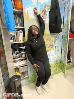 Woman Leaning Against Wall With Painting In Closet GIF