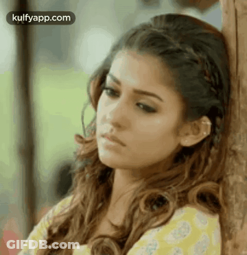 Woman Leaning Against Wooden Post GIF
